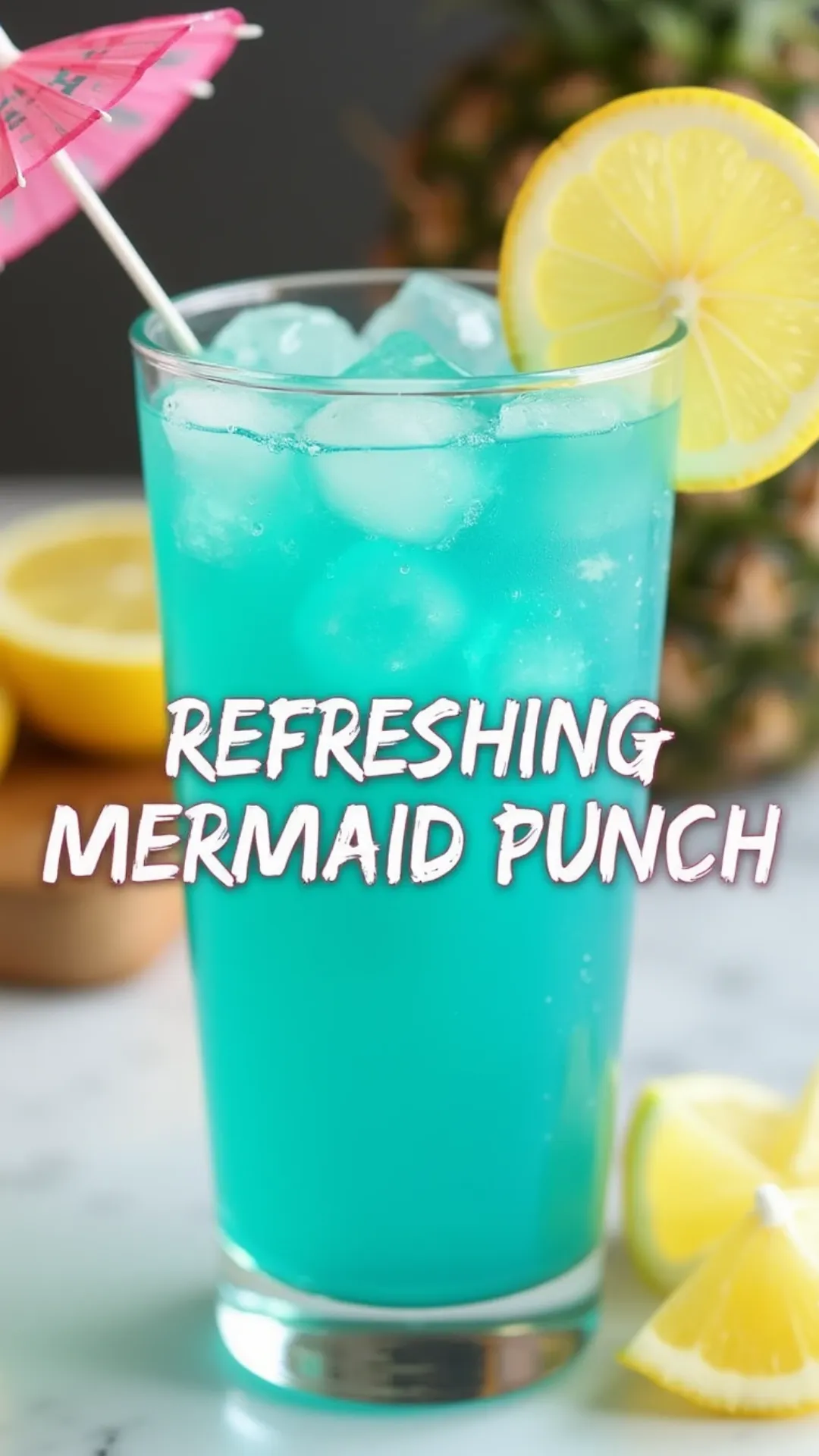 Refreshing blue summer drink with pink cocktail umbrella and fresh lemon slices on marble counter