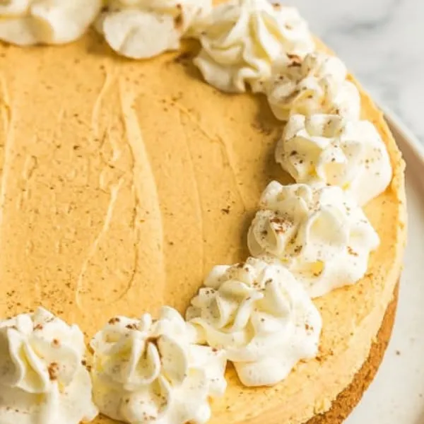 Garlic butter steak bites plated on a crisp parmesan cake with butter rosettes